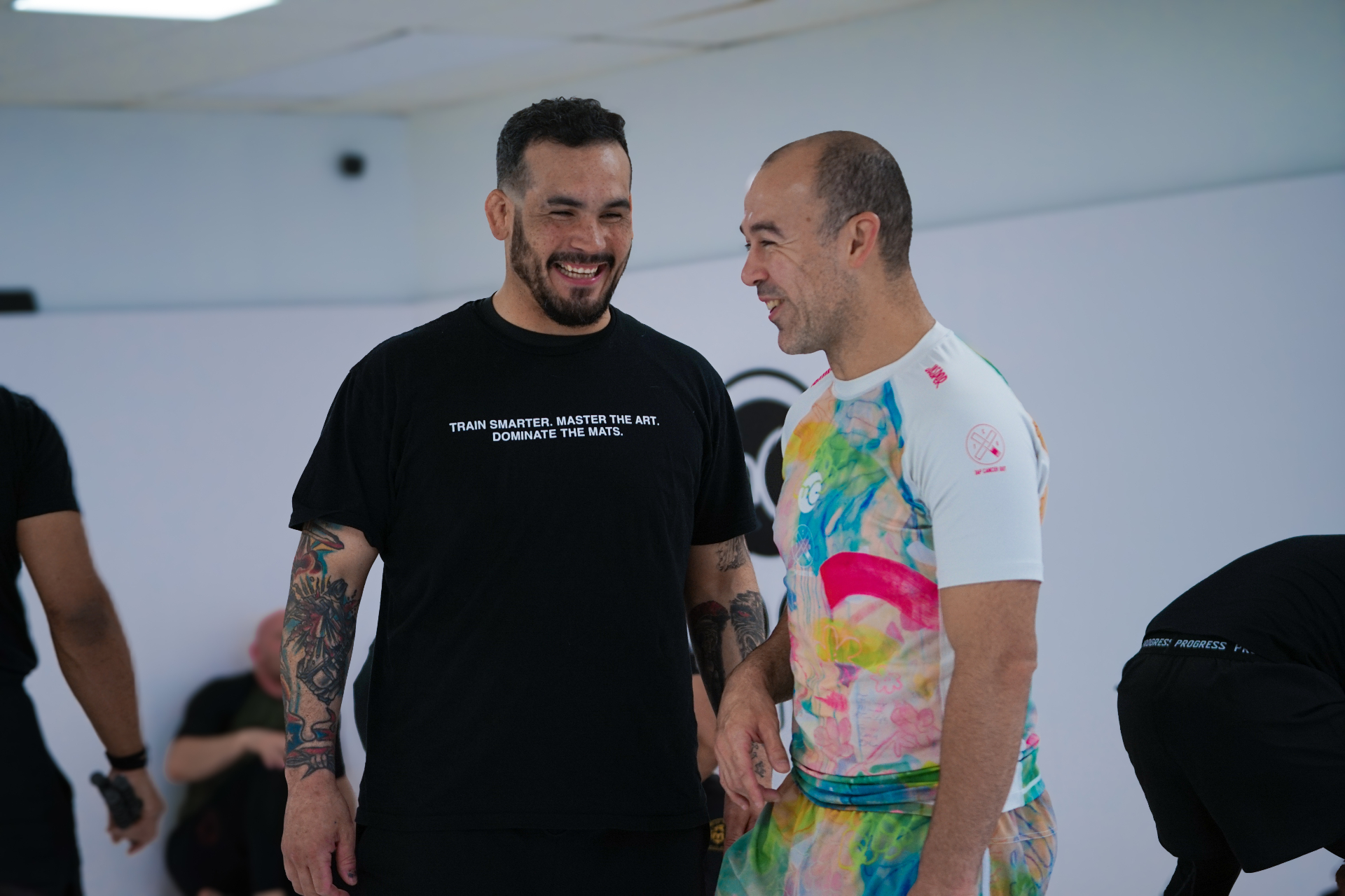 Marcelo Garcia and Manuel Morales sharing a laugh on the mats